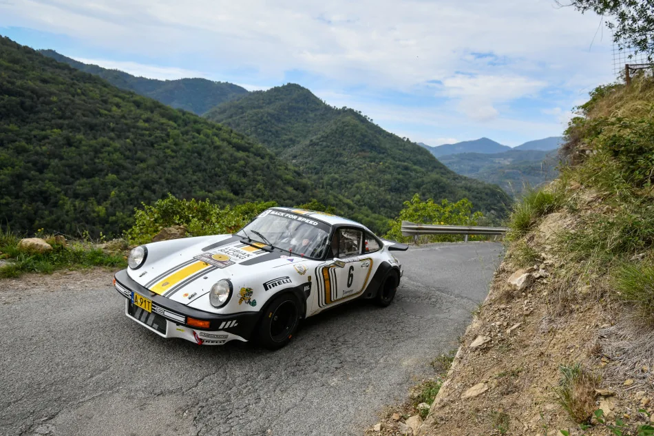 Historic Porsche 911 rally car on a mountain road