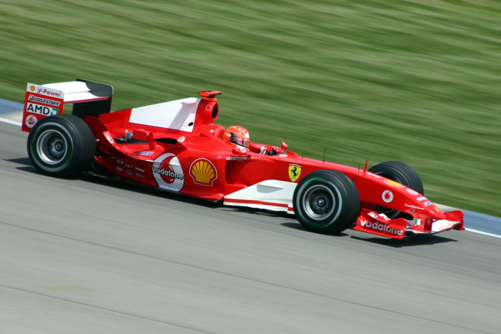 Michael Schumacher drives the red number 1 Ferrari F2004 on track at Indianapolis in 2004.