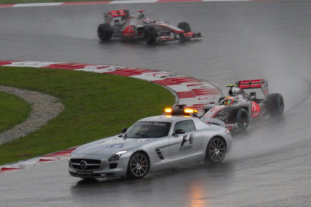 The safety car with Lewis Hamilton and Jenson Button at the 2012 Malaysian Grand Prix before the race was temporarily suspended.