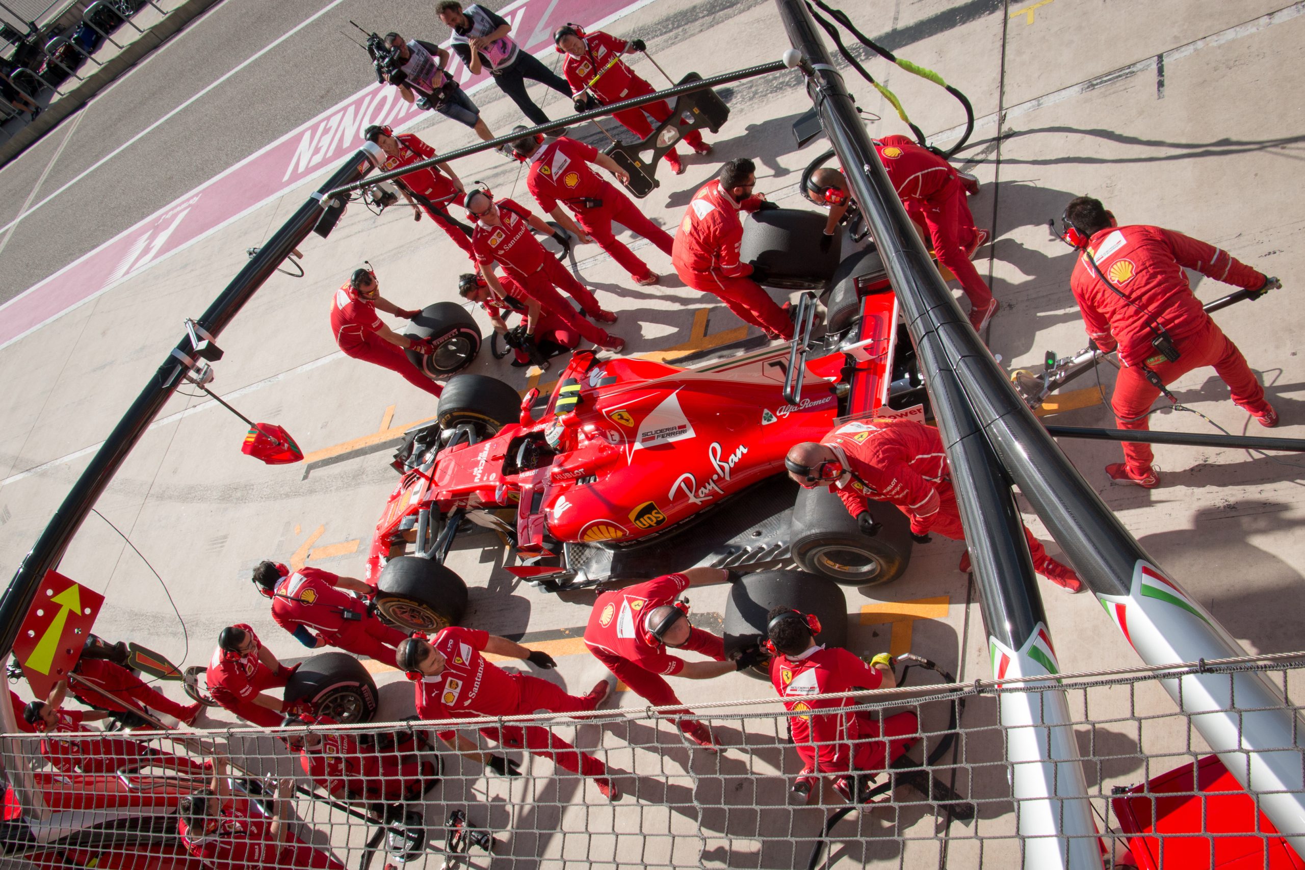 Ferrari pit crew members service Kimi Räikkönen's SF70H in the pit box during the 2017 United States Grand Prix weekend at Circuit of the Americas.