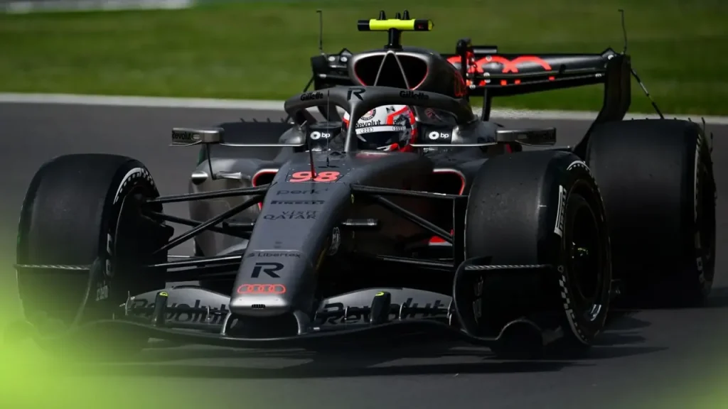 Front view of an Audi Formula 1 car driving on a racetrack.