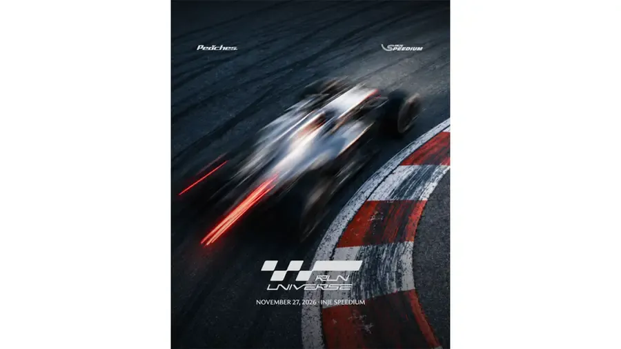 Promotional poster showing an overhead view of a motion-blurred formula race car on track beside a red and white kerb, with Peaches, Inje Speedium, and Run Universe event text.